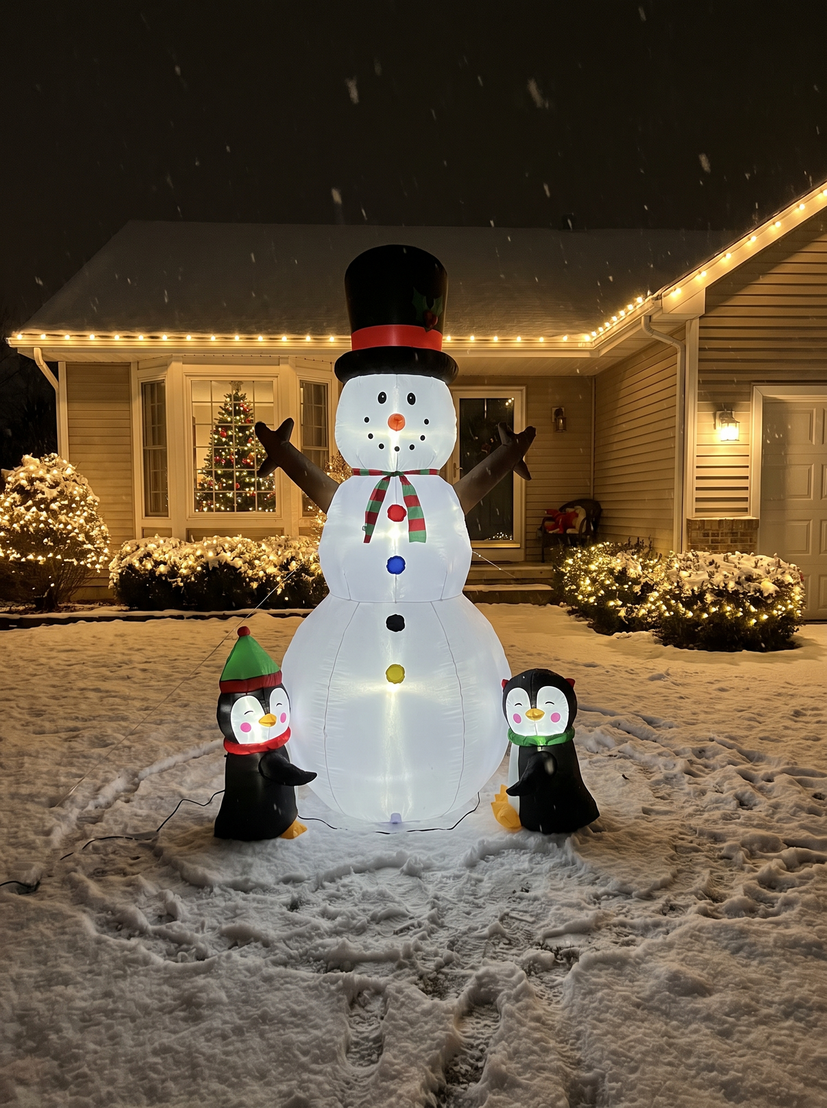 Snowman with Penguins Inflatable, Bright and Colorful at Night